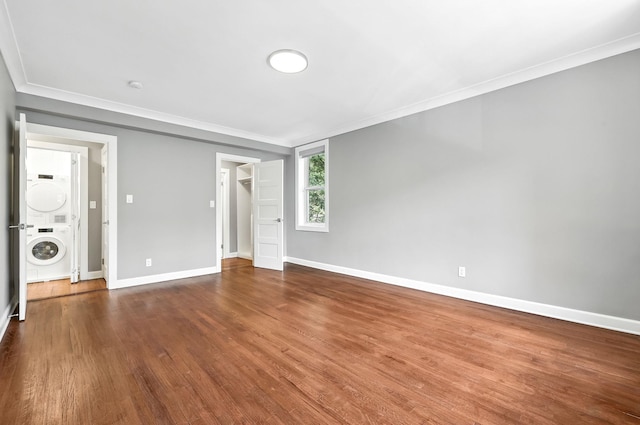 1133 Midland Ave Unit 4E, Bronxville, NY 10708 - unfurnished room with stacked washing machine and dryer, ornamental molding, and dark wood-type flooring