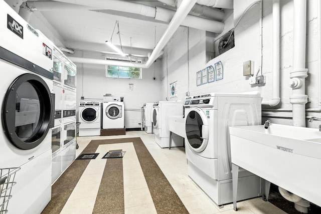 1133 Midland Ave Unit 4E, Bronxville, NY 10708 - communal laundry room with washer and dryer, estacked washer and dryer, light tile patterned floors, and inlaid floor details