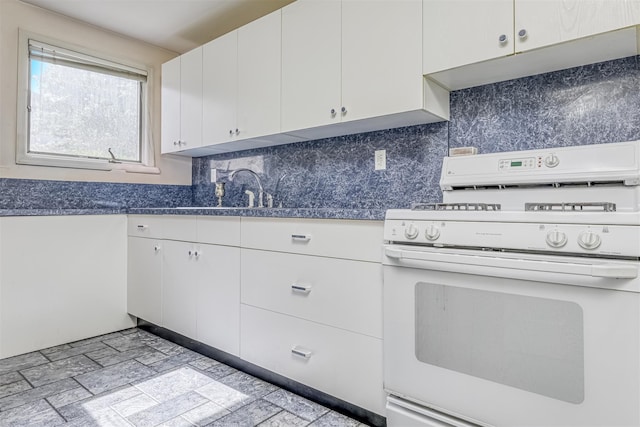 41 N Quince Ln, Monsey, NY 10952 - kitchen featuring white gas range, white cabinets, and backsplash