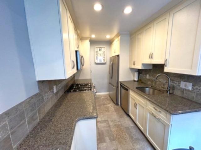 257 Cedarhurst Ave Unit A 8, Cedarhurst, NY 11516 - kitchen featuring appliances with stainless steel finishes, tasteful backsplash, recessed lighting, white cabinets, and dark stone counters
