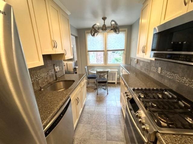 257 Cedarhurst Ave Unit A 8, Cedarhurst, NY 11516 - kitchen featuring stainless steel appliances, a chandelier, decorative backsplash, and radiator