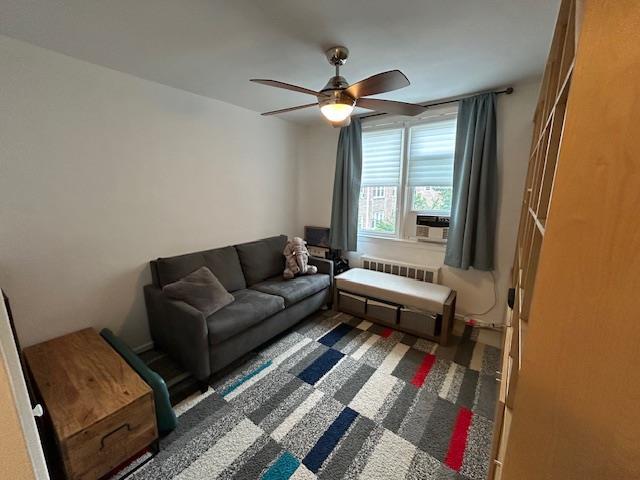 257 Cedarhurst Ave Unit A 8, Cedarhurst, NY 11516 - living room featuring radiator heating unit, ceiling fan, and cooling unit