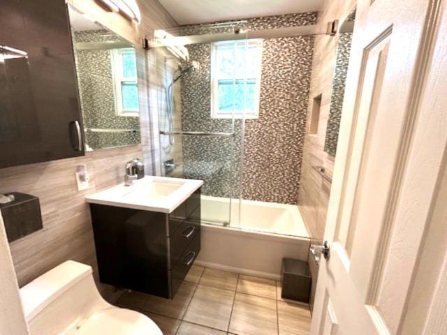 257 Cedarhurst Ave Unit A 8, Cedarhurst, NY 11516 - full bath with tile patterned floors, enclosed tub / shower combo, vanity, plenty of natural light, and tile walls