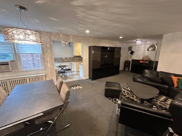 257 Cedarhurst Ave Unit A 8, Cedarhurst, NY 11516 - living area with radiator heating unit, recessed lighting, and carpet flooring