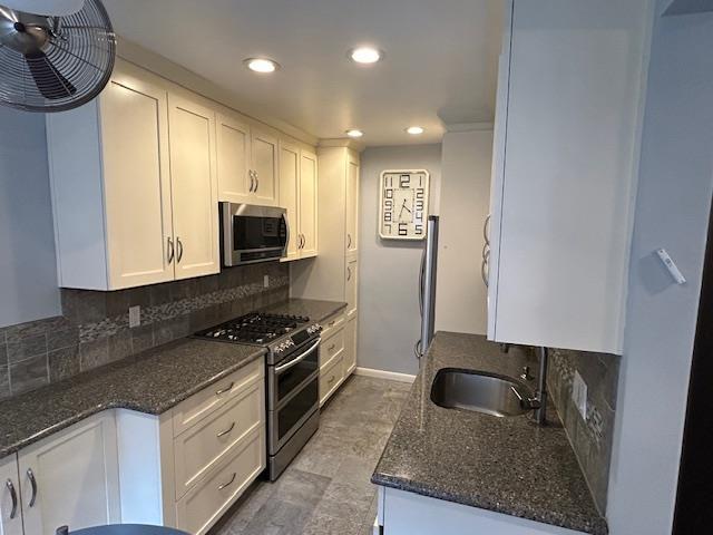 257 Cedarhurst Ave Unit A 8, Cedarhurst, NY 11516 - kitchen featuring appliances with stainless steel finishes, backsplash, white cabinetry, recessed lighting, and dark stone countertops