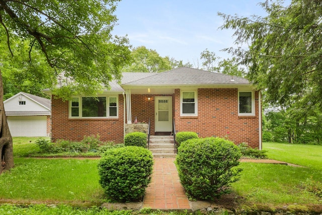 65 Hortontown Rd, Carmel, NY 10512 - view of front facade with a front lawn, brick siding, a detached garage, and a shingled roof