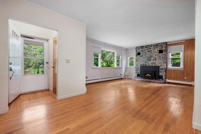 65 Hortontown Rd, Carmel, NY 10512 - unfurnished living room featuring a baseboard radiator, light wood-style flooring, and plenty of natural light