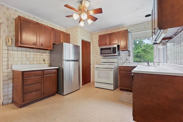65 Hortontown Rd, Carmel, NY 10512 - kitchen with stainless steel appliances, wallpapered walls, light flooring, ceiling fan, and light countertops