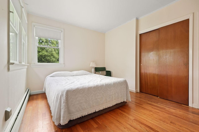 65 Hortontown Rd, Carmel, NY 10512 - bedroom featuring baseboard heating, light wood-type flooring, and a closet