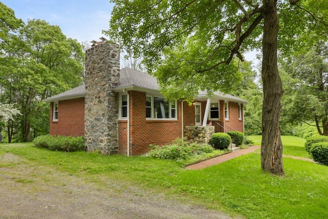 65 Hortontown Rd, Carmel, NY 10512 - view of front of house with a front yard, brick siding, a chimney, and a shingled roof