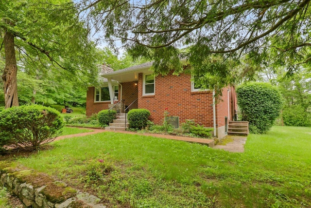 65 Hortontown Rd, Carmel, NY 10512 - view of front of home featuring brick siding, a front lawn, and a chimney