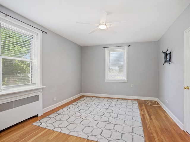90 Bryant Ave Unit 3Da, White Plains, NY 10605 - unfurnished room with radiator heating unit, light wood-style floors, a ceiling fan, and plenty of natural light