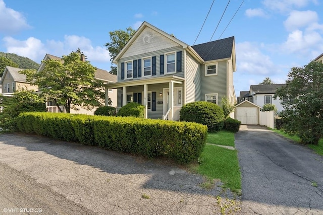 65 Union St, Beacon, NY 12508 - view of front of house with a detached garage, a storage unit, and a porch