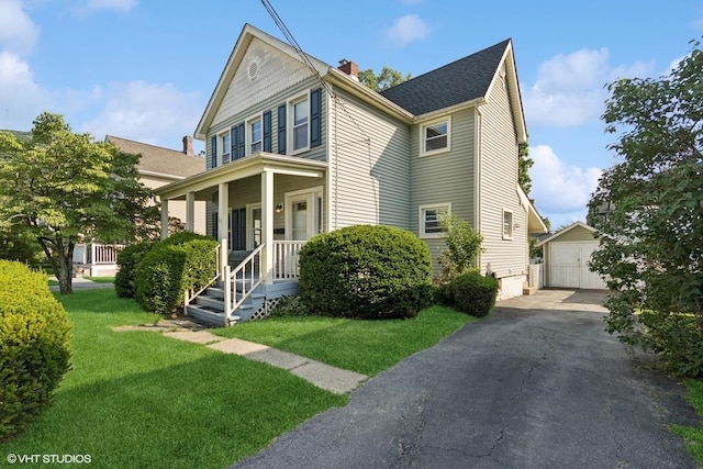 65 Union St, Beacon, NY 12508 - view of front of home featuring a chimney, a detached garage, a front yard, and an outbuilding