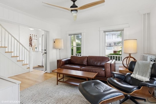 65 Union St, Beacon, NY 12508 - living area featuring ornamental molding, light wood-style flooring, a ceiling fan, and stairway