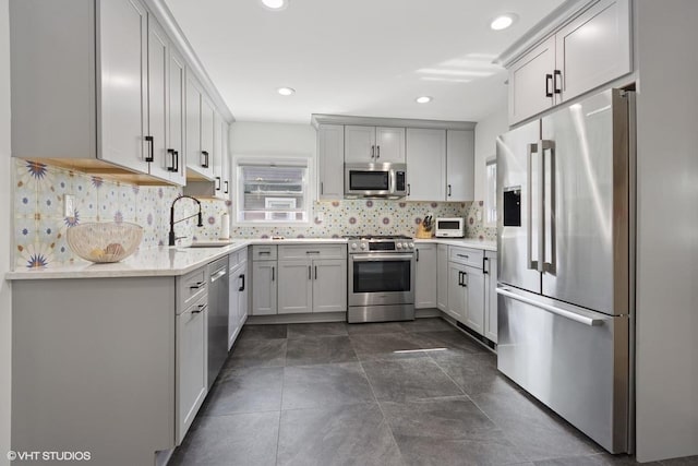 65 Union St, Beacon, NY 12508 - kitchen with appliances with stainless steel finishes, decorative backsplash, recessed lighting, and gray cabinets