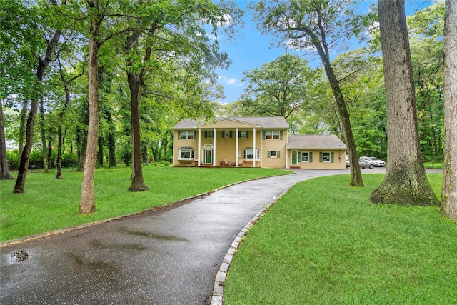 5 Linda Ct, Oyster Bay, NY 11771 - neoclassical home with asphalt driveway, a front yard, and covered porch