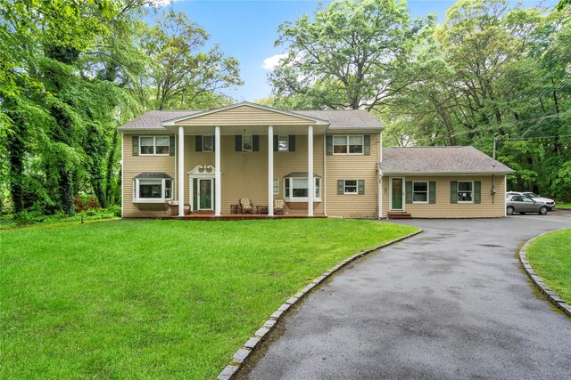 5 Linda Ct, Oyster Bay, NY 11771 - neoclassical home with a front lawn, asphalt driveway, and a shingled roof