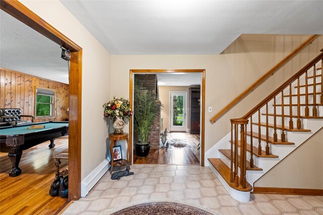 5 Linda Ct, Oyster Bay, NY 11771 - foyer entrance with stairway, billiards, wood finished floors, and wooden walls