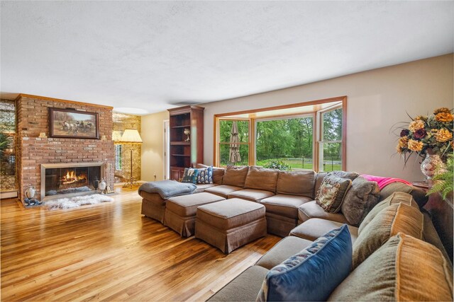 5 Linda Ct, Oyster Bay, NY 11771 - living area featuring light wood finished floors and a brick fireplace