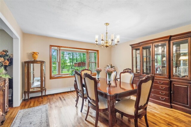 5 Linda Ct, Oyster Bay, NY 11771 - dining area with a chandelier, light wood-type flooring, and a baseboard heating unit