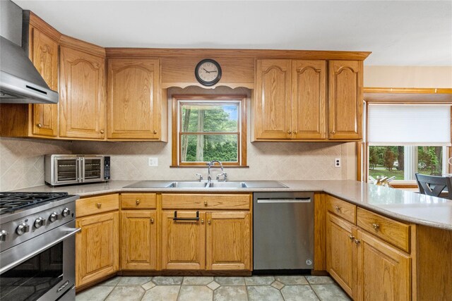 5 Linda Ct, Oyster Bay, NY 11771 - kitchen with stainless steel appliances, wall chimney range hood, a peninsula, and light countertops