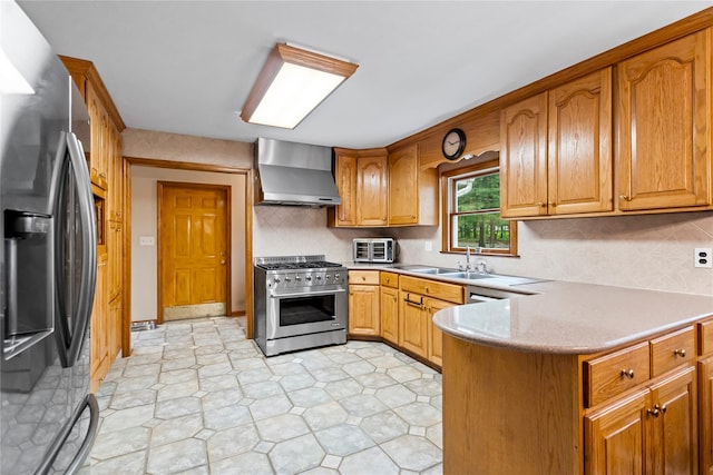 5 Linda Ct, Oyster Bay, NY 11771 - kitchen featuring appliances with stainless steel finishes, wall chimney exhaust hood, a peninsula, brown cabinetry, and decorative backsplash