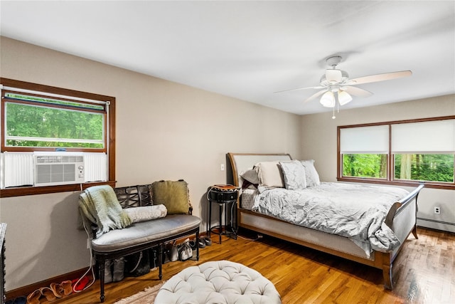 5 Linda Ct, Oyster Bay, NY 11771 - bedroom with cooling unit, a baseboard radiator, wood finished floors, and ceiling fan