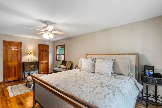 5 Linda Ct, Oyster Bay, NY 11771 - bedroom with a baseboard radiator, wood finished floors, ceiling fan, and cooling unit