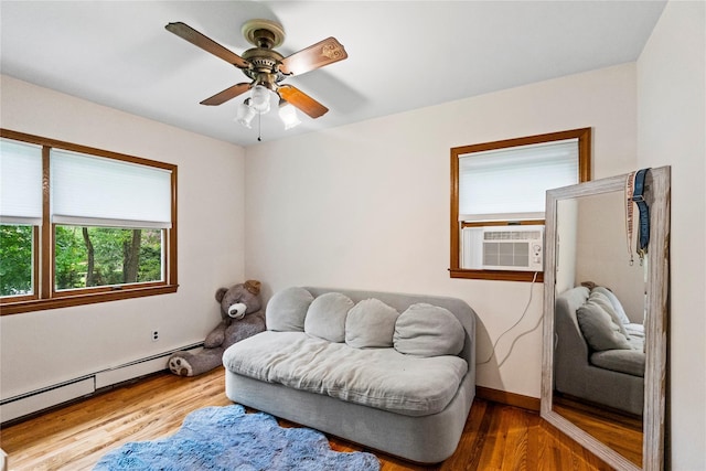 5 Linda Ct, Oyster Bay, NY 11771 - sitting room with baseboard heating, cooling unit, wood finished floors, and ceiling fan