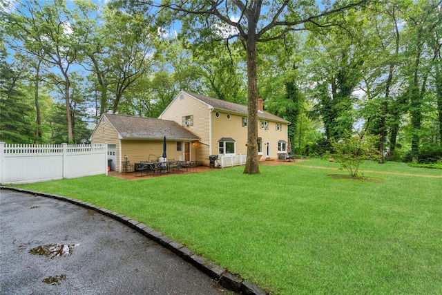 5 Linda Ct, Oyster Bay, NY 11771 - rear view of house featuring a patio area and a chimney