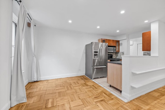 5425 Valles Ave Unit 1L, Bronx, NY 10471 - kitchen with stainless steel appliances, tasteful backsplash, recessed lighting, brown cabinets, and dark countertops