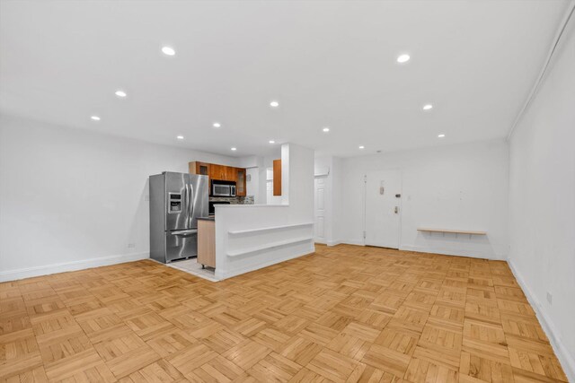 5425 Valles Ave Unit 1L, Bronx, NY 10471 - unfurnished living room featuring baseboards and recessed lighting
