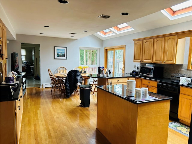6 Cedarfield Ter, Setauket, NY 11780 - kitchen with a skylight, black dishwasher, stainless steel microwave, dark countertops, and vaulted ceiling