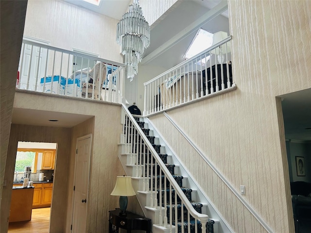 6 Cedarfield Ter, Setauket, NY 11780 - staircase with a high ceiling, a chandelier, and wood finished floors