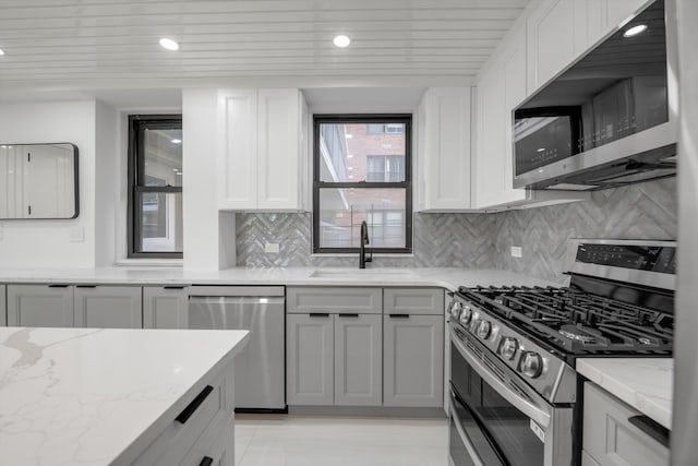 4705 Henry Hudson Pkwy W Unit 6J, Bronx, NY 10471 - kitchen with appliances with stainless steel finishes, light stone counters, backsplash, white cabinetry, and recessed lighting