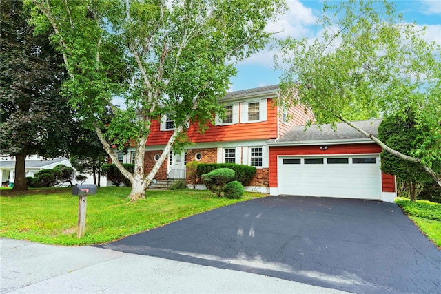 4 Pasture Ln, Poughkeepsie, NY 12603 - colonial house featuring an attached garage, asphalt driveway, a front lawn, and brick siding