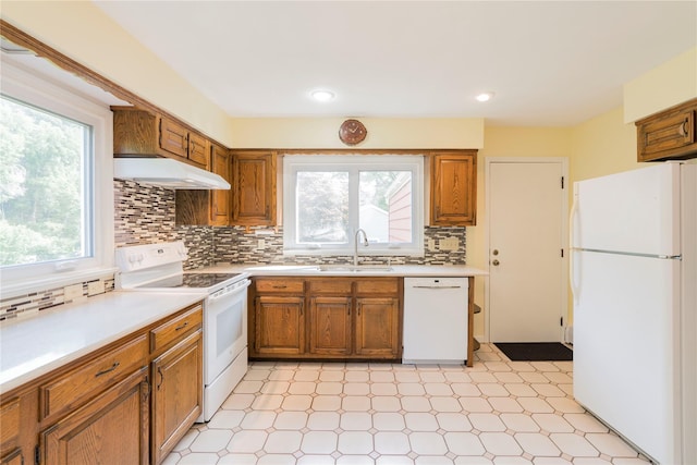 4 Pasture Ln, Poughkeepsie, NY 12603 - kitchen with white appliances, brown cabinets, light countertops, light flooring, and recessed lighting