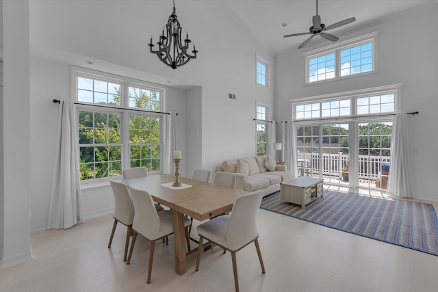 18 Tall Tree Cir, Jamesport, NY 11901 - dining room featuring light wood-style flooring, high vaulted ceiling, ceiling fan, crown molding, and a chandelier