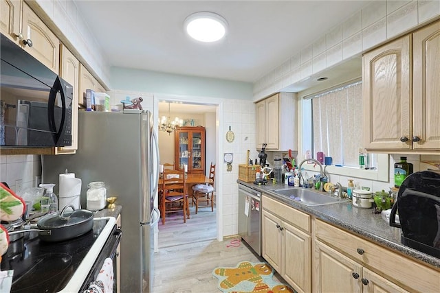 18 Larch Ct, Fishkill, NY 12524 - kitchen with black microwave, stainless steel dishwasher, a chandelier, light wood-style floors, and dark countertops