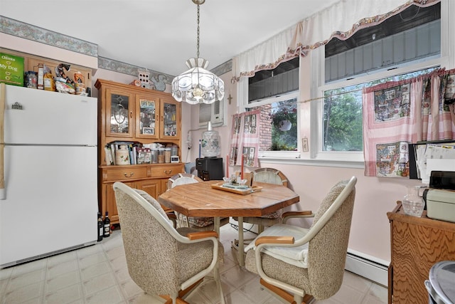 114 Halgren Cres, Haverstraw, NY 10927 - dining room with a chandelier, a baseboard radiator, and light flooring