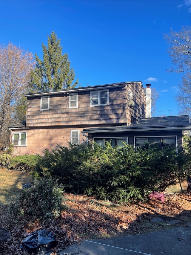 6 Nevada Ave, Medford, NY 11763 - view of side of property featuring a chimney and mansard roof