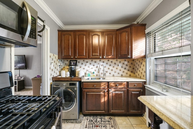 520 Tuckahoe Rd Unit 3B, Yonkers, NY 10710 - kitchen featuring washer / dryer, stainless steel microwave, gas range oven, tasteful backsplash, and crown molding