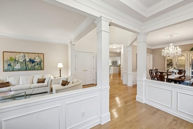 15 Louden Loop, Mount Sinai, NY 11766 - living room with decorative columns, light wood-style floors, ornamental molding, a chandelier, and a decorative wall