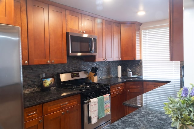 95 N Broadway Unit D2-5, White Plains, NY 10603 - kitchen featuring appliances with stainless steel finishes, tasteful backsplash, and dark stone countertops