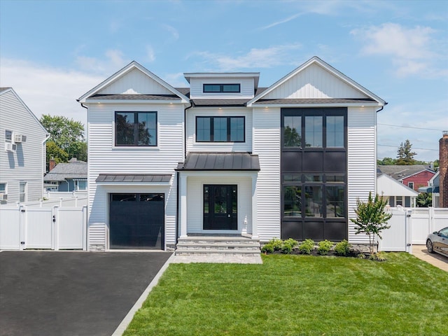 724 Pleasant Ave, Westbury, NY 11590 - view of front of house featuring a gate, a standing seam roof, asphalt driveway, a metal roof, and an attached garage