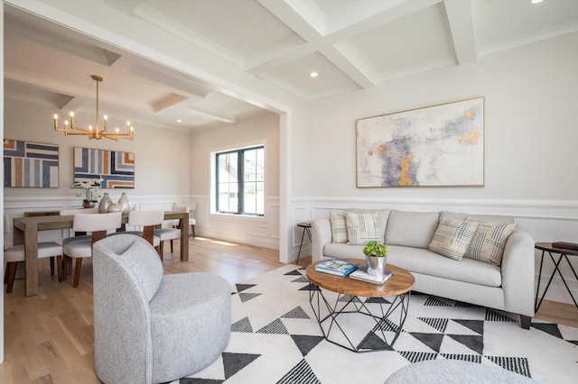724 Pleasant Ave, Westbury, NY 11590 - living room with coffered ceiling, beamed ceiling, light wood-style flooring, a chandelier, and wainscoting
