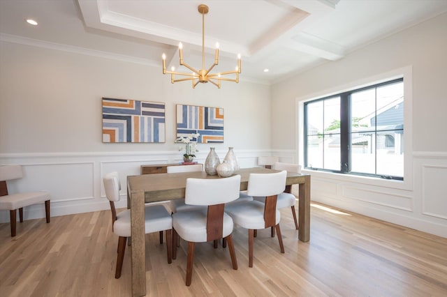 724 Pleasant Ave, Westbury, NY 11590 - dining area with a chandelier, a decorative wall, light wood finished floors, crown molding, and a wainscoted wall