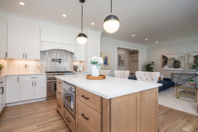 724 Pleasant Ave, Westbury, NY 11590 - kitchen with high end stove, decorative backsplash, light wood-style floors, a center island, and light countertops