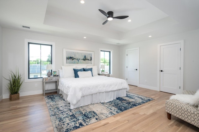 724 Pleasant Ave, Westbury, NY 11590 - bedroom with a tray ceiling, recessed lighting, light wood finished floors, and ceiling fan